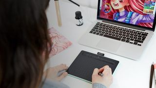 Best Wacom tablets; a woman draws on a computer screen using a tablet