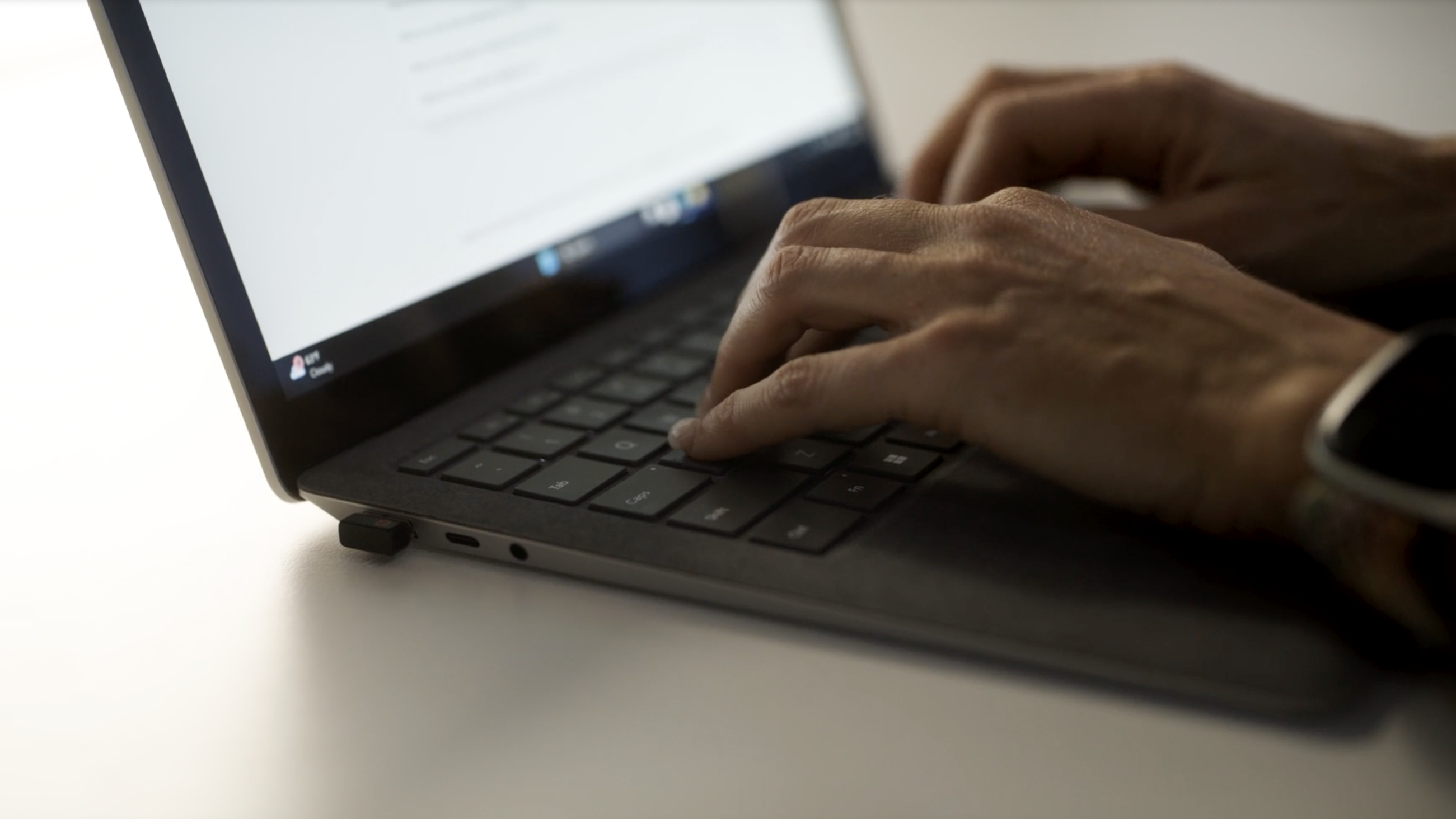 Hands typing on a Copilot+ laptop