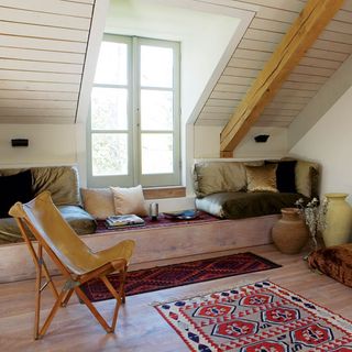 attic room with wooden flooring and chair