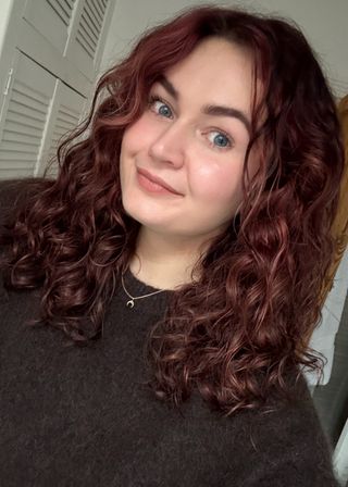 Lucy with curly hair after using the Dyson Chitosan Pre-Style Cream and Post-Style Serum