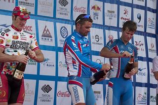 Stage eight podium (l-r): Brad Huff (2nd,Jelly Belly), Alexey Markov (1st,Russian National Team), and Ivan Kovalev (3rd,Russian National Team) prepare to spray photographers in Dongfang.