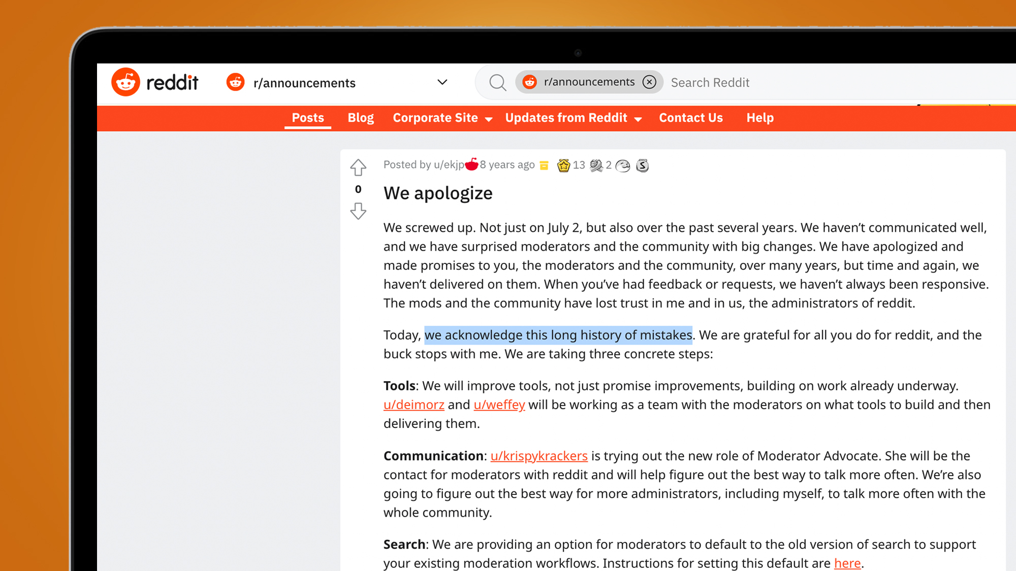A laptop on an orange background showing an apology from the Reddit CEO in 2015