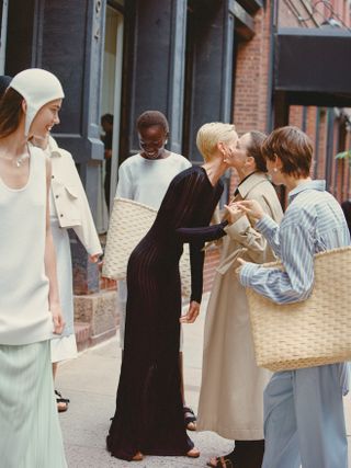 models from the maria mcmanus show gathering on the sidewalk