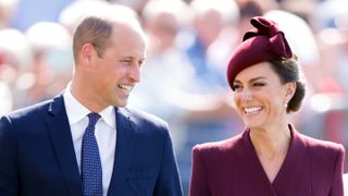 Prince William, Prince of Wales and Catherine, Princess of Wales smile at each other in St Davids, Wales in 2023