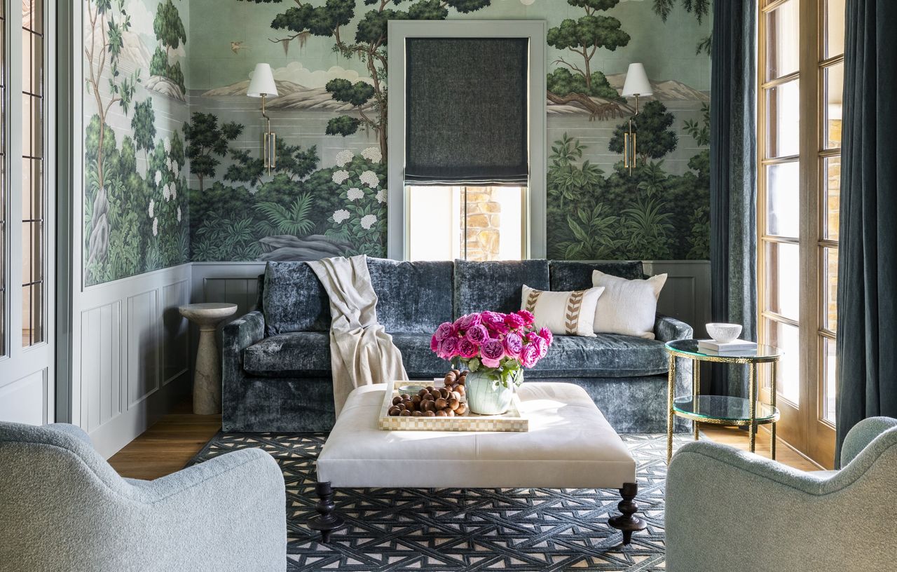 A living room with a painted chair rail and wallpaper