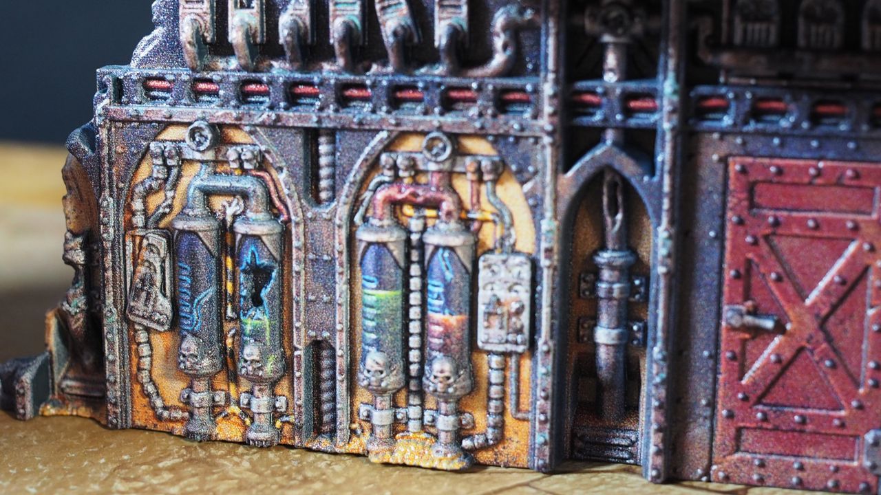Numerous multicolor vials and instruments in a ruined miniature building