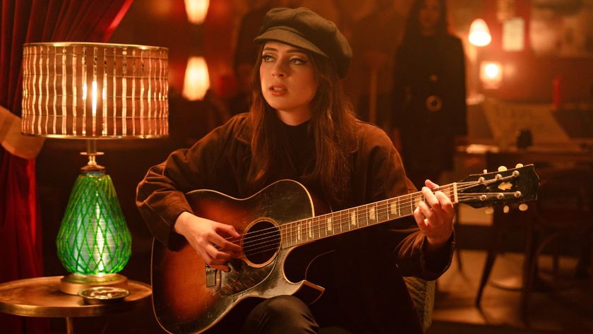 Lizzy McAlpine playing the guitar in School Spirits. 