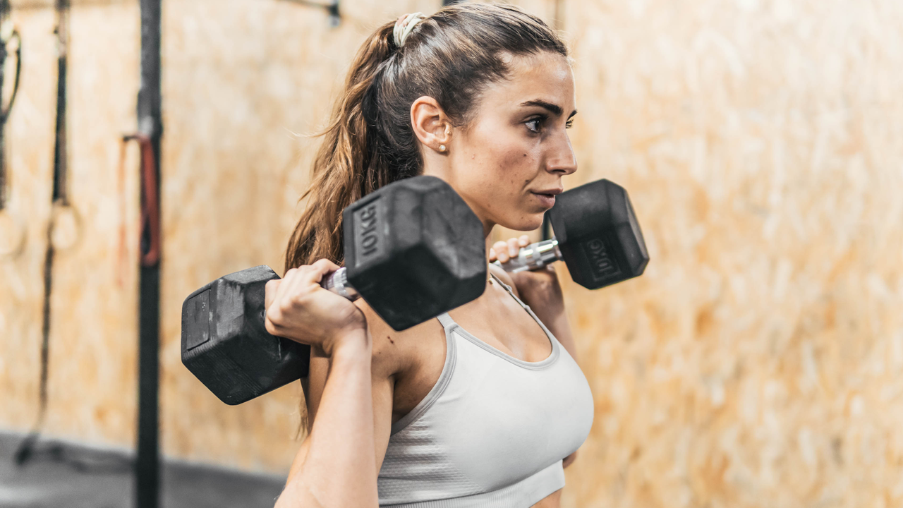 Woman doing dumbbell push press