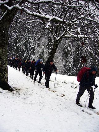 Team Vorarlberg-Corratec members hike through the snow during its team building exercise.