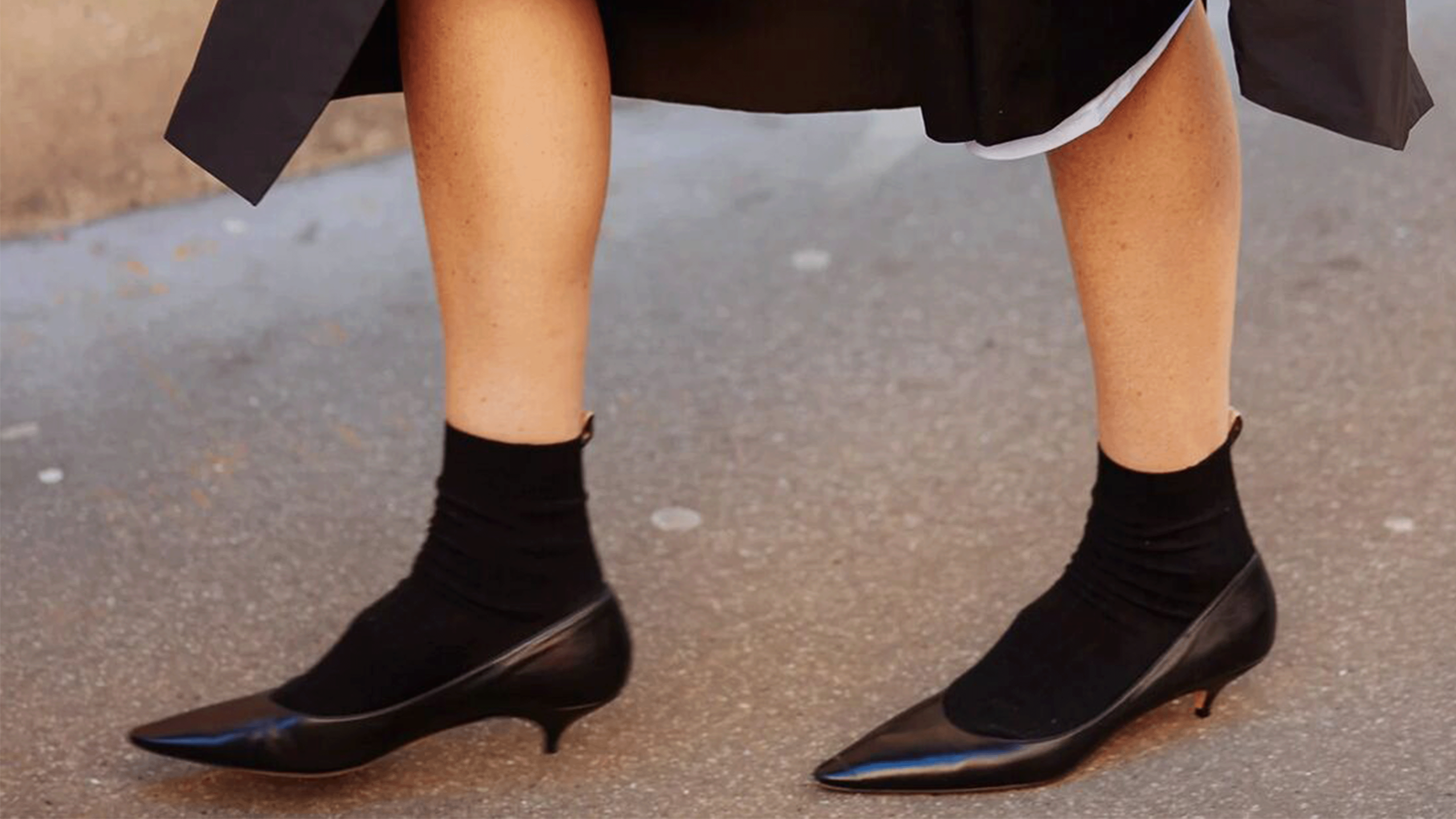 Person wearing pointed-toe kitten-heel pumps.