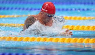 Adam Peaty of Great Britain competes in the final of the Men's 100m Breaststroke on day three of the Tokyo 2020 Olympic Games
