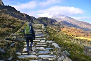 Hiker climbing Snowdon by the Pyg tack. Snowdonia National Park