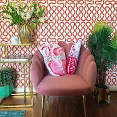 wallpaper on wall with armchair and potted plant
