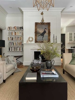small white living room painted in Benjamin Moore's Swiss Coffee by Kelly Hopter