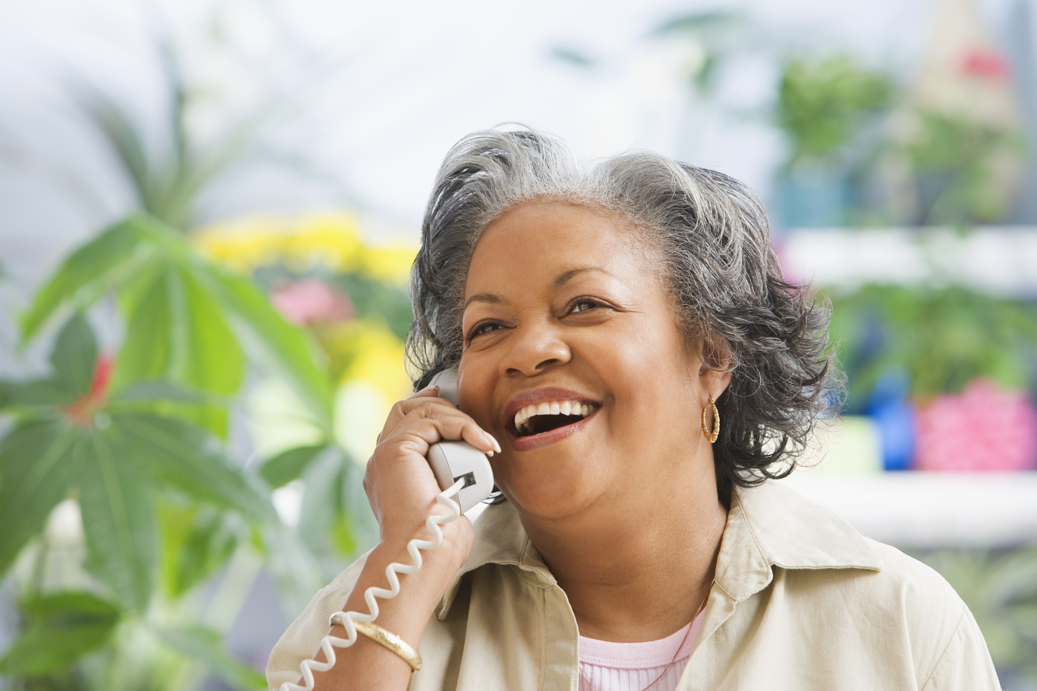 Woman talking on her land line phone. 