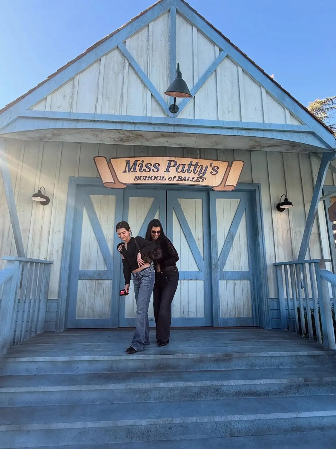 Penelope Disick and Kourtney Kardashian posing in front of Miss Patty's School of Ballet in a photo Kardashian shared on Instagram from their recent visit to the Gilmore Girls' set.