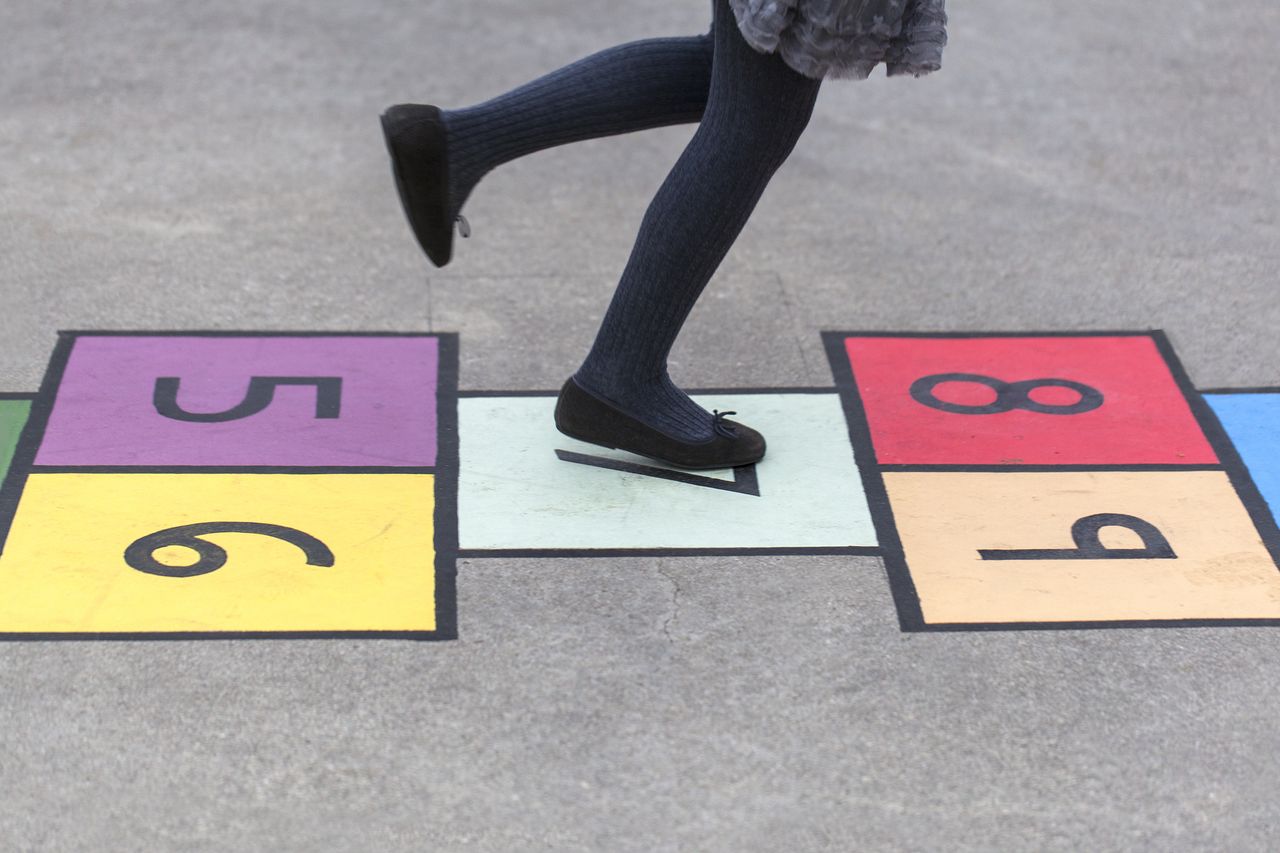 Child playing hopscotch.