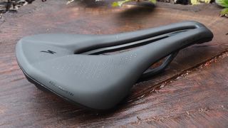 Specialized Power Expert saddle sitting on a piece of wood