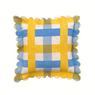 A yellow and blue outdoor cushion with scallop edges