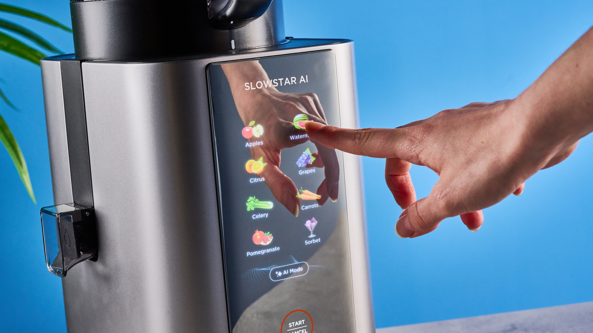 Tribest Slowstar AI Vertical Hopper Juicer photographed in front of a blue background