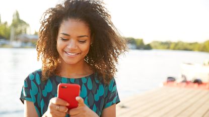 Woman using a smartphone looking happy