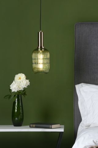 A bedside lamp emitting green light