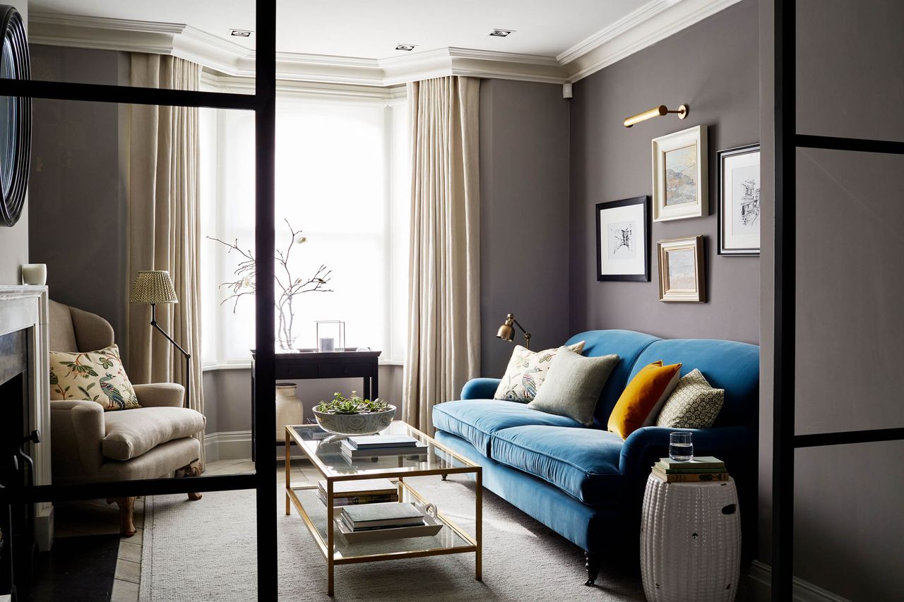 Pillows on a sofa in a purple-hued living room