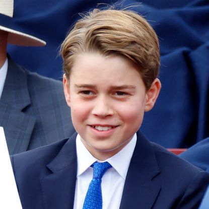 Prince GEorge wearing a navy suit and tie