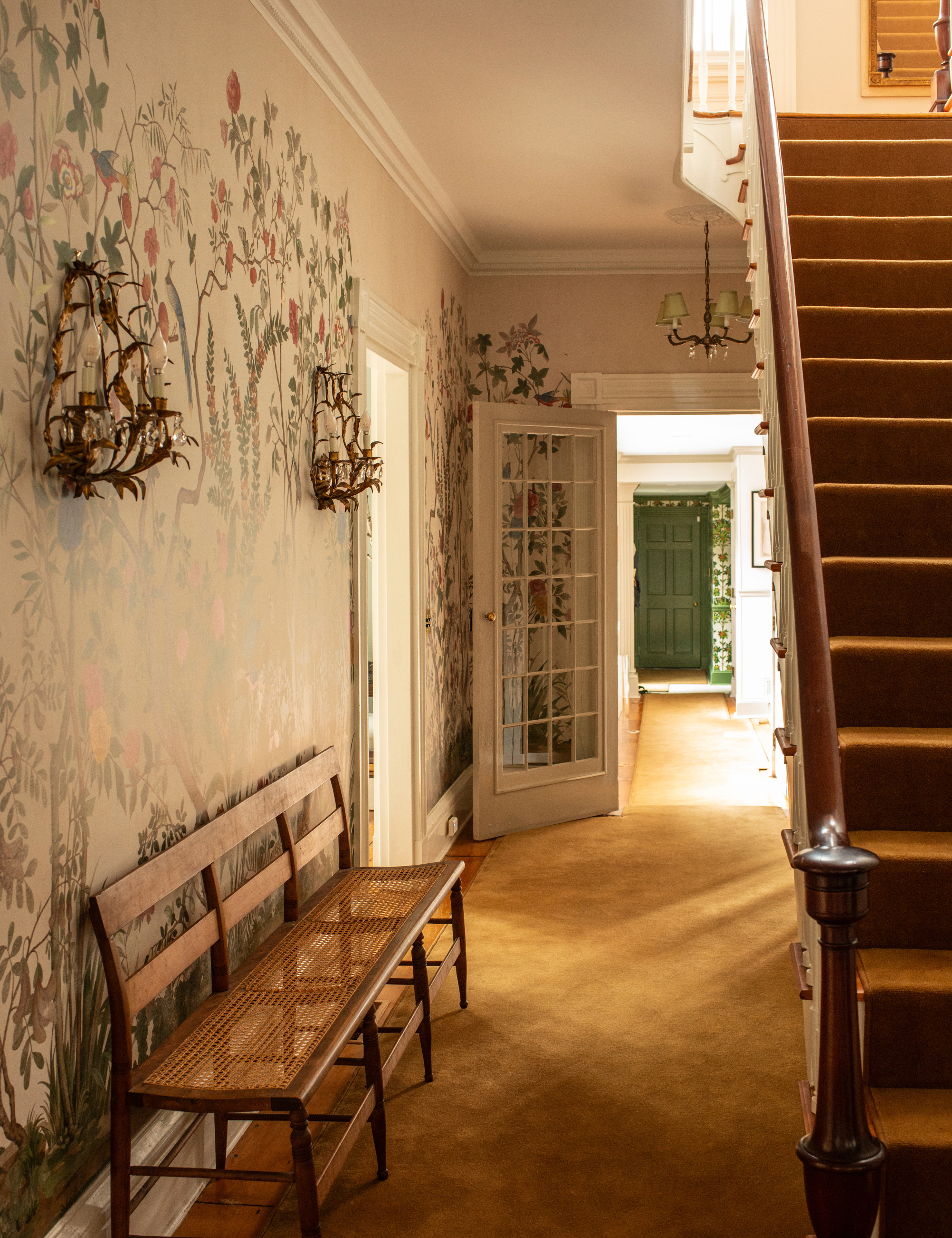 Whimsical floral-filled entryway of a Colonial home