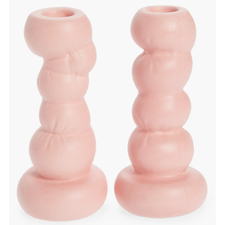 two pink candlesticks in a stacked round pillow design