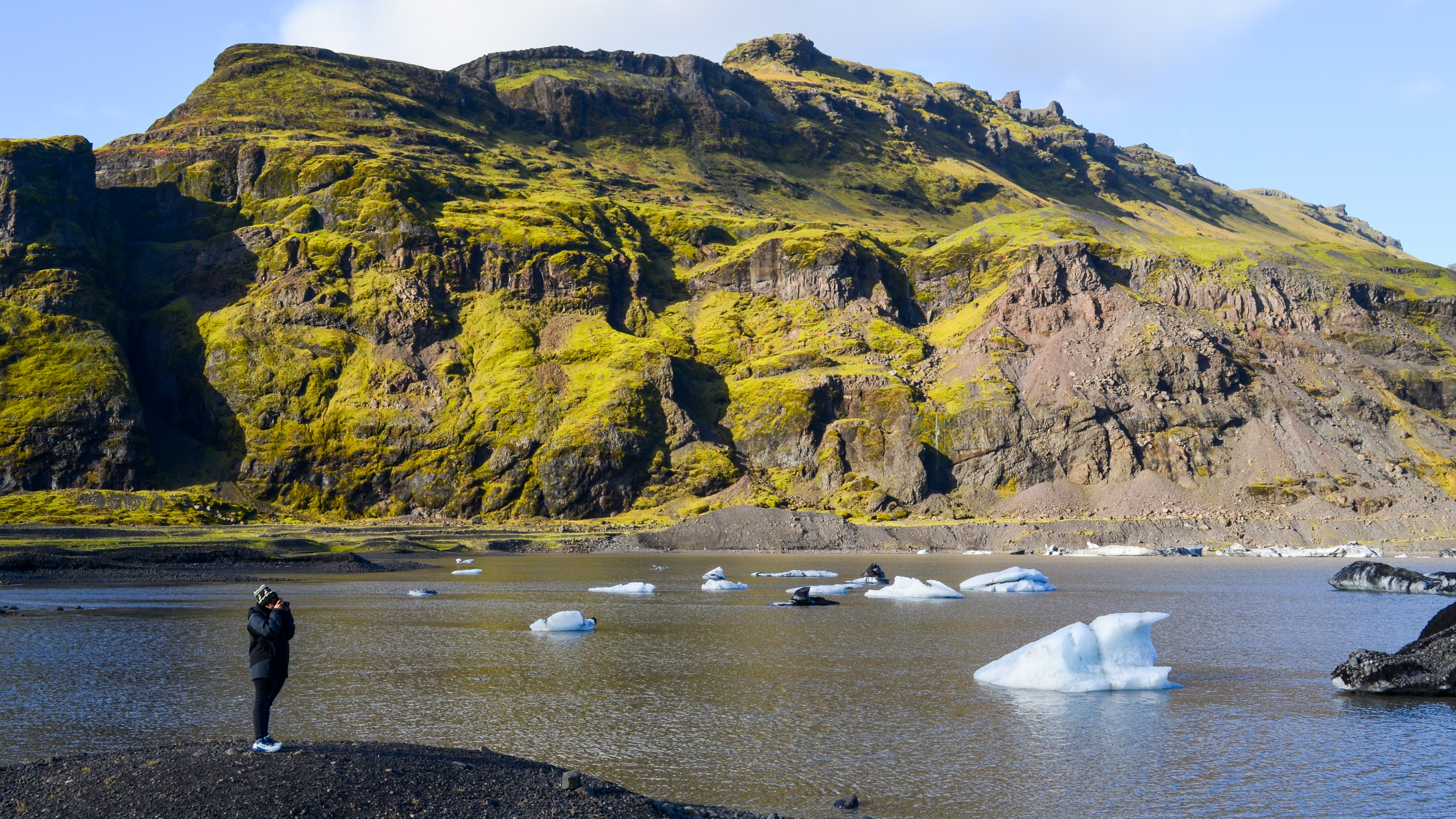 A person taking a photo of the Icelandic landscape