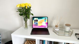 Apple iPad Pro 13-inch M4 tablet on white sideboard next to yellow roses