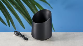 a black plastic coffee doser with an aesthetically pleasing design and a curved built-in LED screen