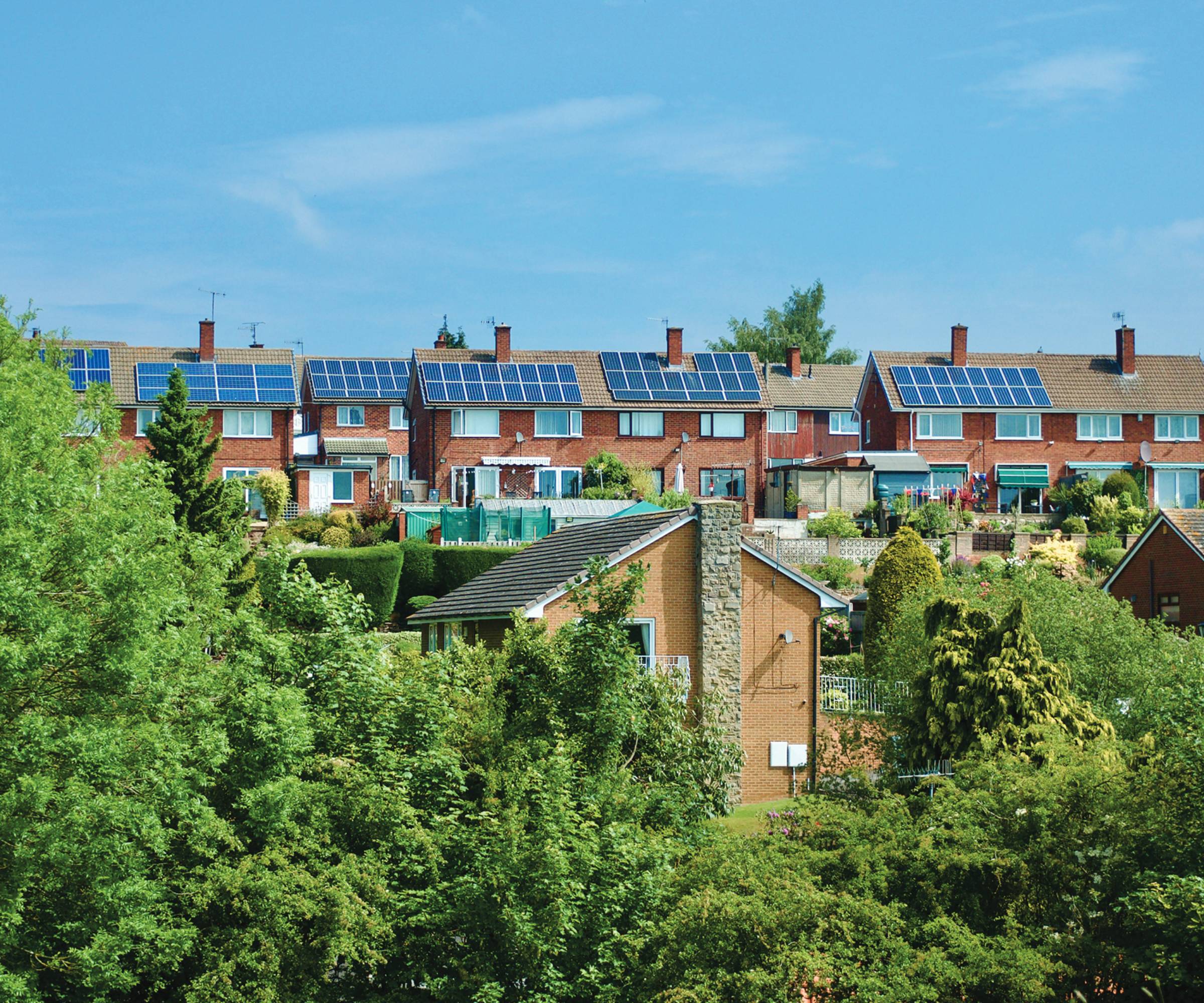 birds eye view of street of houses with many of them having solar panels on roofs