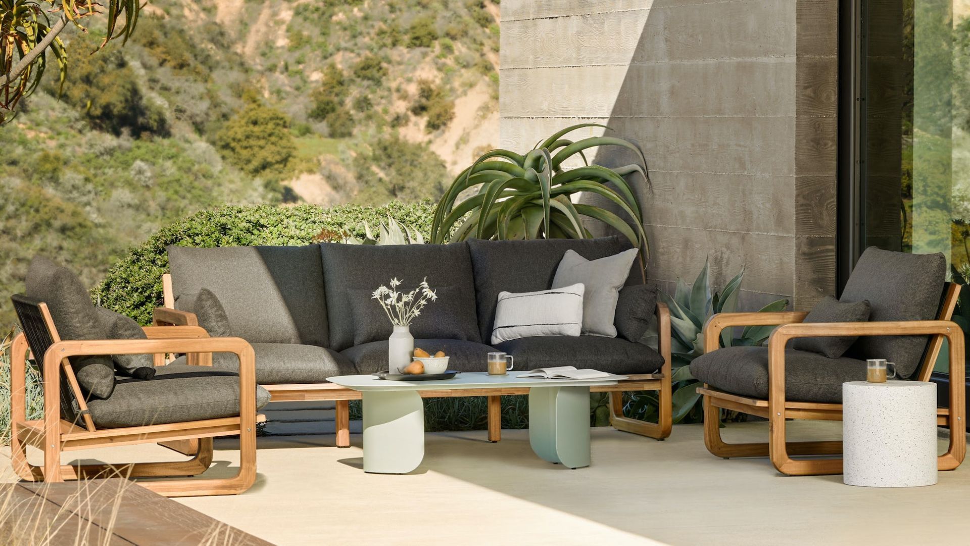 Article's Skane Green coffee table and a sectional on a patio for the best outdoor furniture brands.