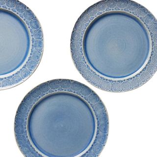 A set of 4 blue subtly patterned dinner plates