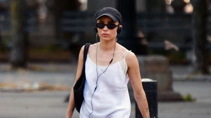 Zoë Kravitz wearing a white mini slip dress with white socks and black loafers in New York City June 2024