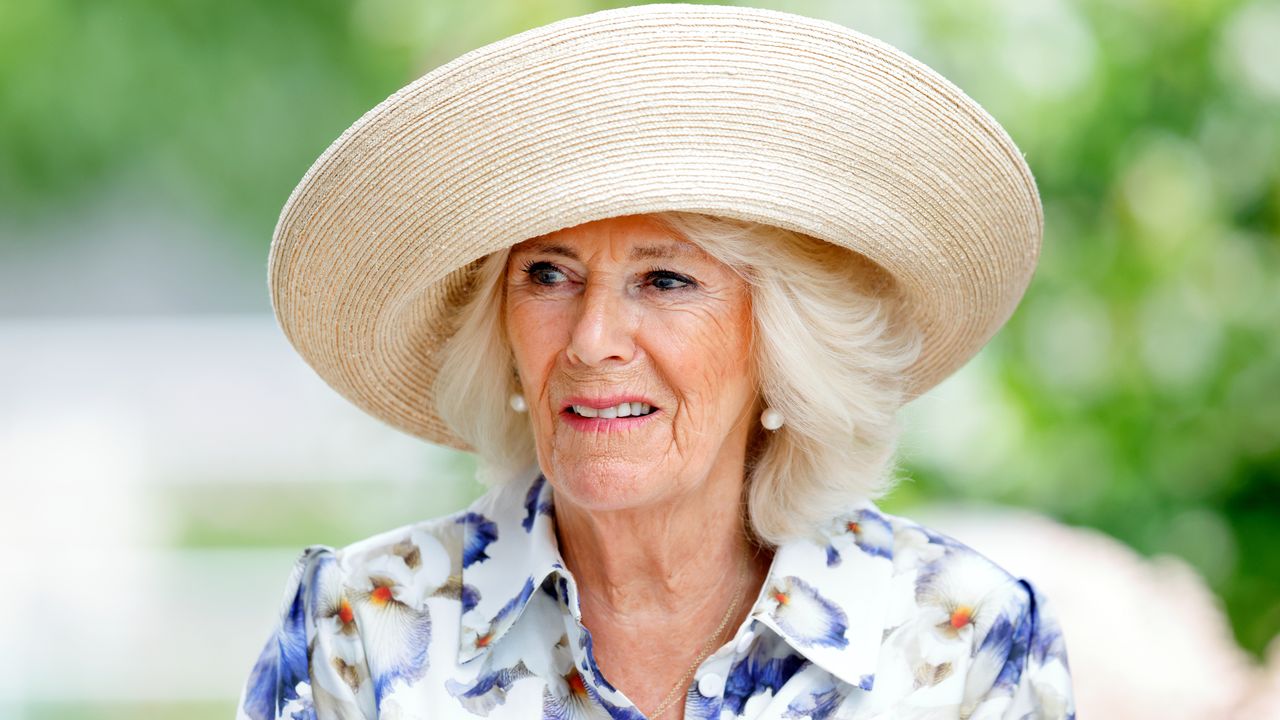 Queen Camilla attends the QIPCO King George Day at Ascot Racecourse wearing a hat and floral dress