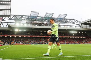 Phil Foden of Manchester City takes the ball to the corner flag during the Premier League match between Liverpool FC and Manchester City at Anfield on October 16, 2022 in Liverpool, England.