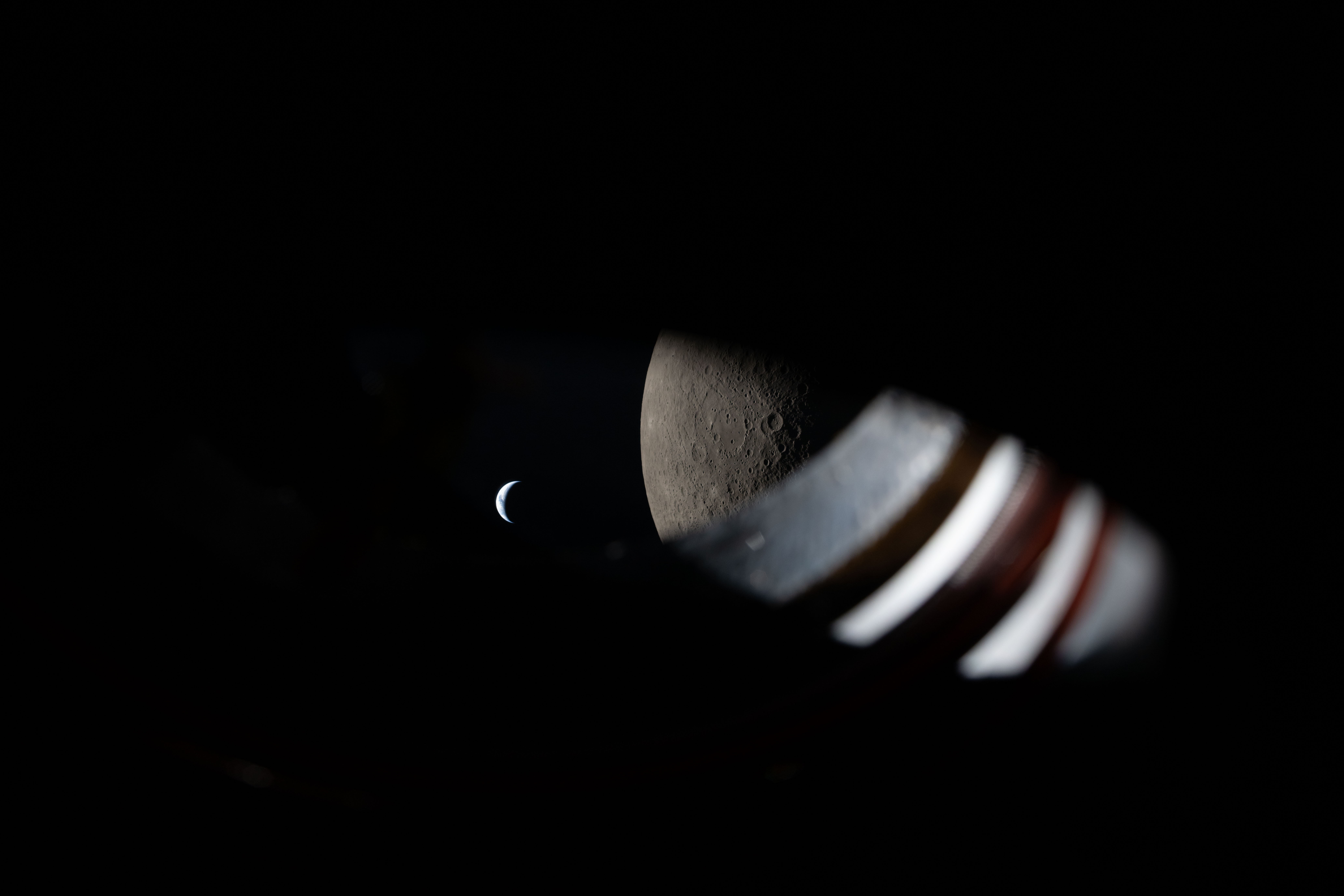 The Moon and Earth outside a window from Orion