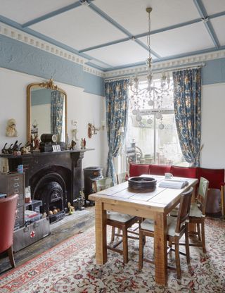 living room with curtains, table, fireplace and mirror