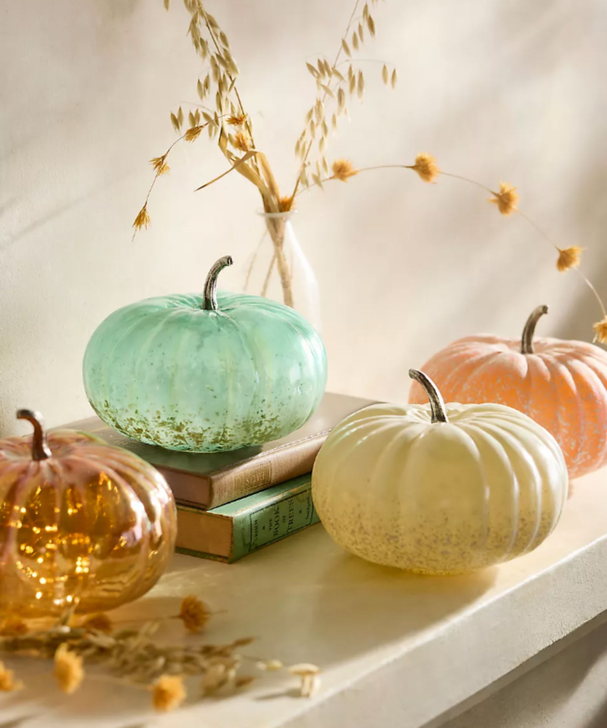 Glass pumpkin decorations in green, orange and neutral