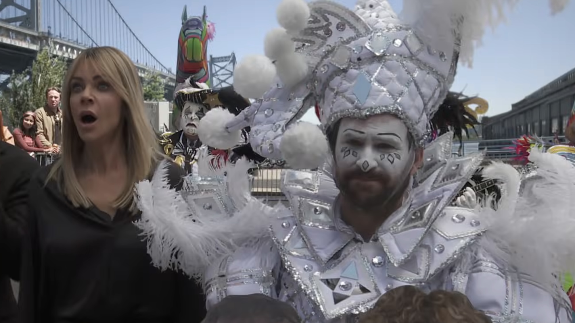 Charlie costumed in silver with a big hat and feathers during parade in It's Always Sunny in Philadelphia Season 18