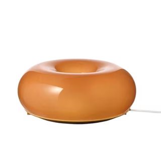 An orange donut shaped lamp