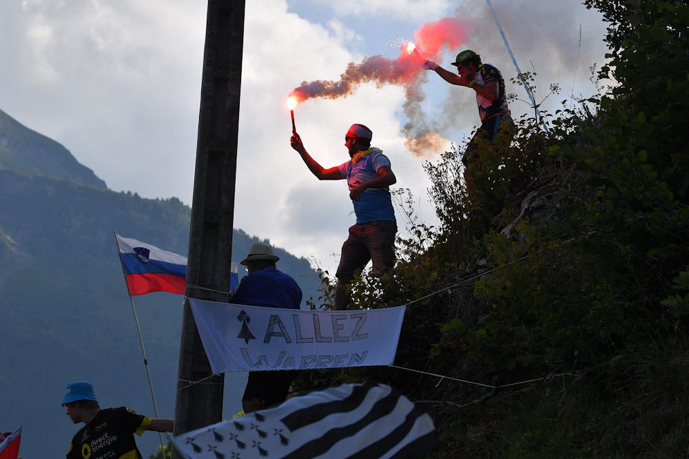 Spectators with flares greet the riders during stage 10 at the tour de France