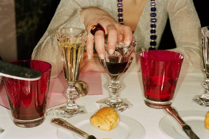 A lady is holding drinks.