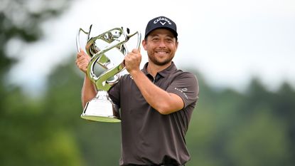 Xander Schauffele poses with the Baycurrent Classic trophy after winning in 2025
