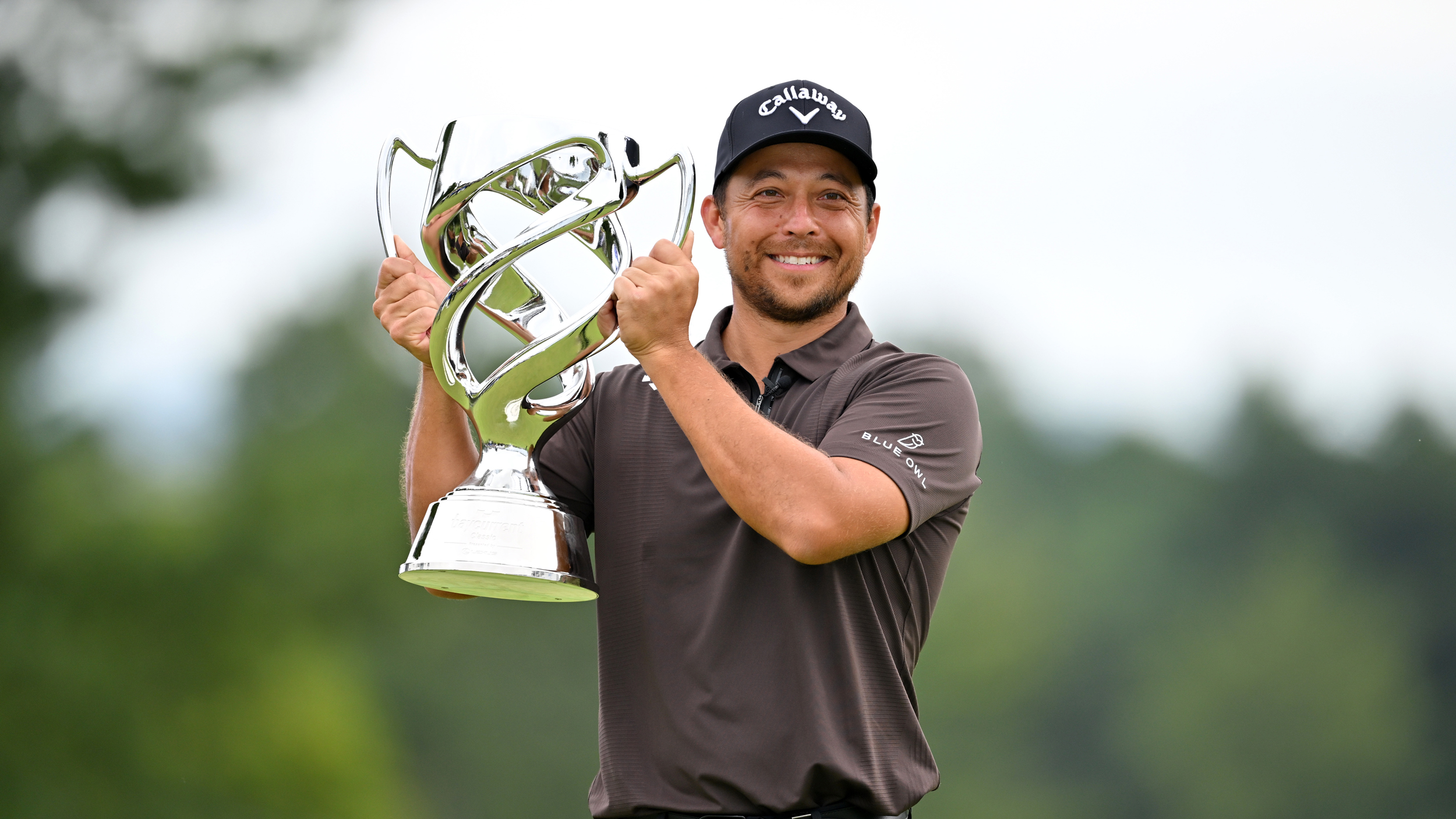 Xander Schauffele poses with the Baycurrent Classic trophy after winning in 2025