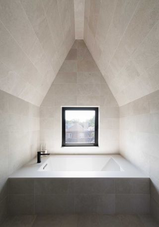 a built in bathtub in a small bathroom