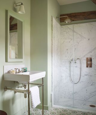 Small shower room with green walls and marble enclosure